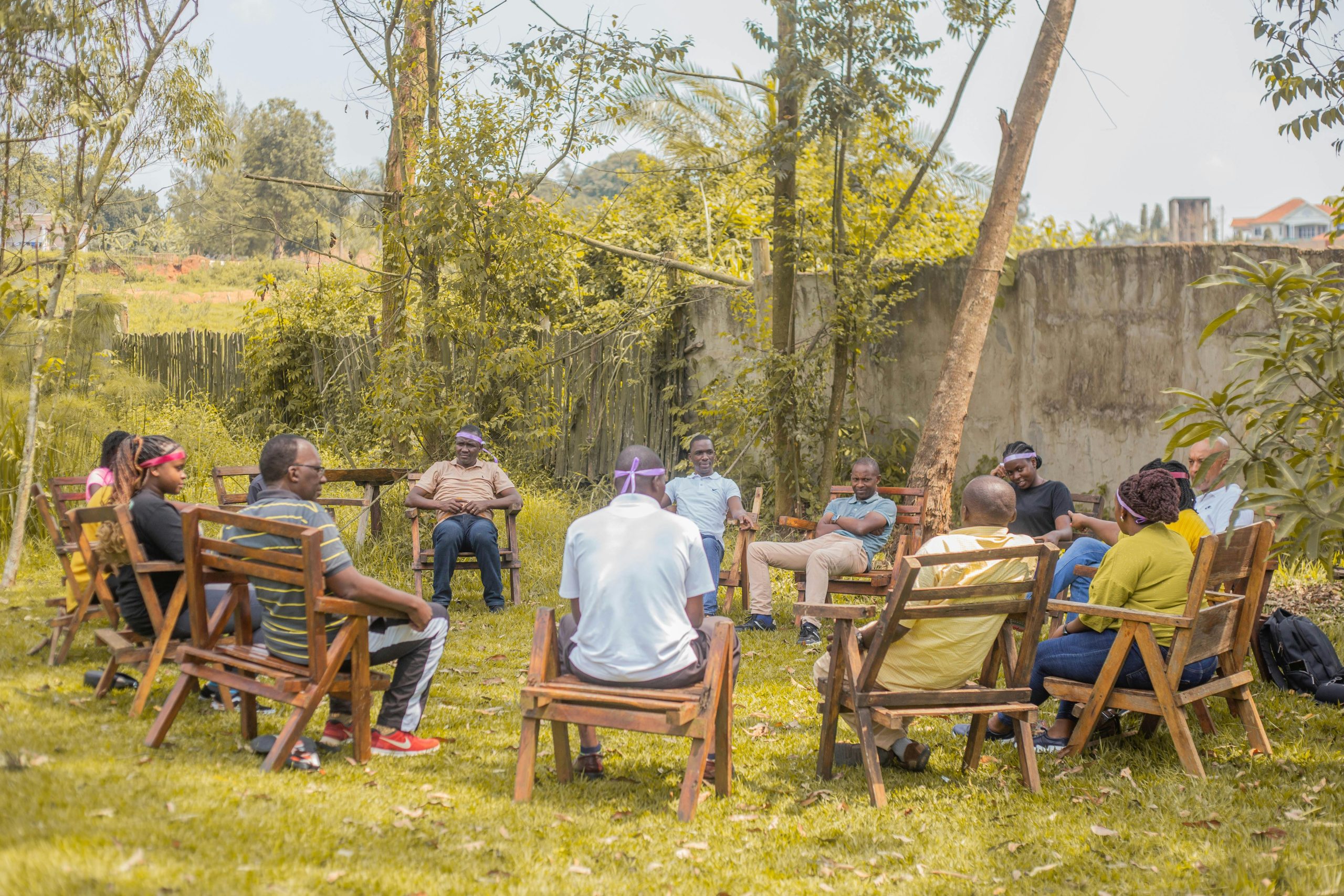 A group of adults having a team meeting outdoors in a garden