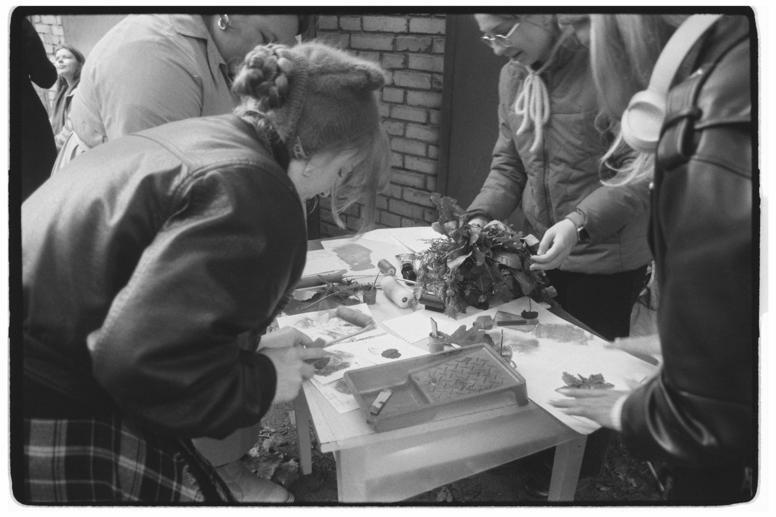 A group of people engaged in an outdoor craft workshop
